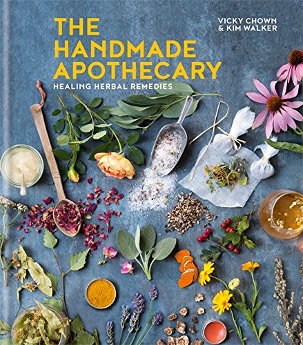 Book cover with herbs, flowers, and apothecary tools on a blue background.