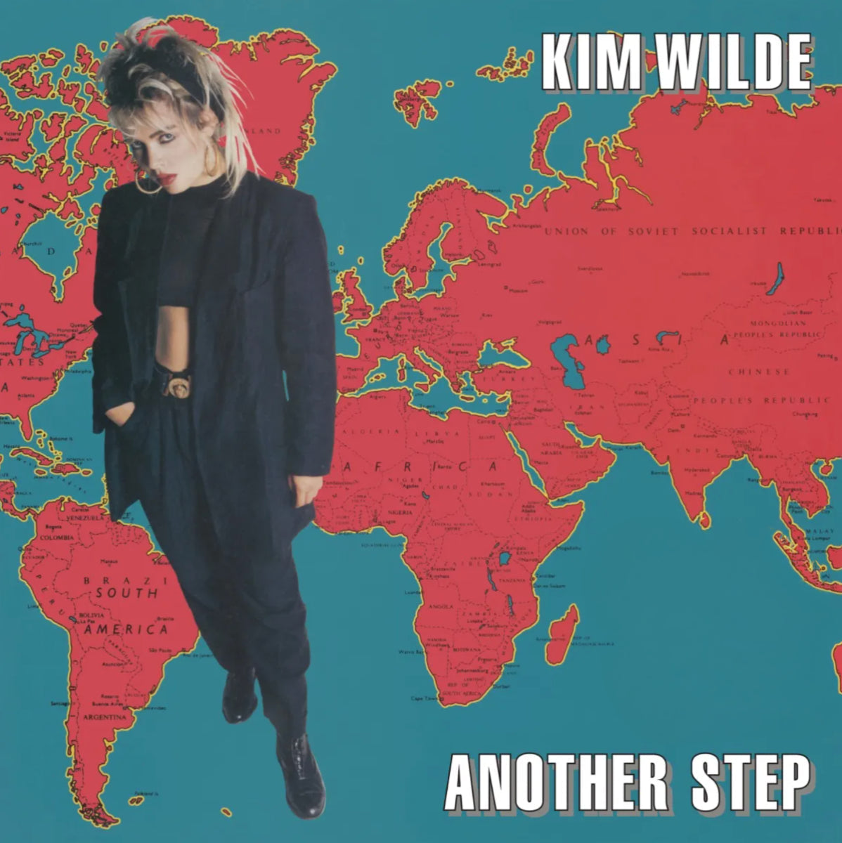 Kim Wilde album cover: portrait with a world map background.
