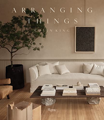 Book cover titled Arranging Things featuring a minimalist living room with a sofa and books.