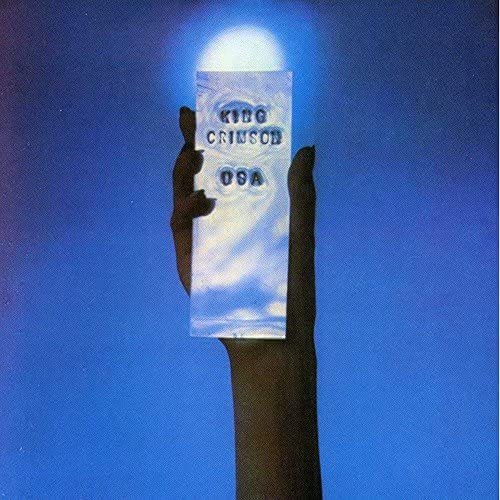 King Crimson “USA” album cover: a hand holding a white rectangle with blue sky.