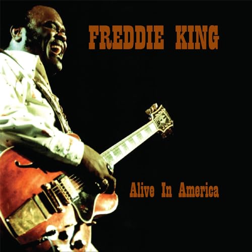 Freddie King playing a red electric guitar, album cover art.