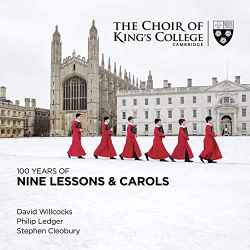Choir members in red robes walk toward King’s College, Cambridge.