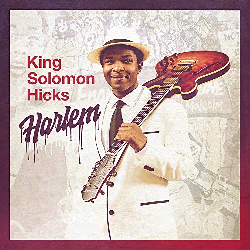 Album cover featuring a man in a white suit holding a guitar.