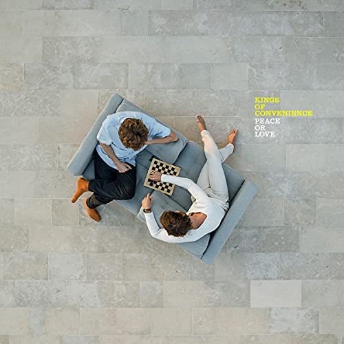 Album cover: two men on a couch playing chess, overhead view.