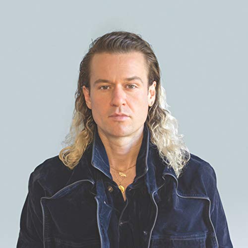 Portrait of John Carroll Kirby, a man with long blonde and brown hair.