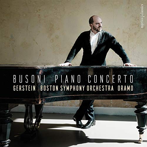 Pianist Kirill Gerstein at a grand piano, album cover for Busoni’s Piano Concerto.