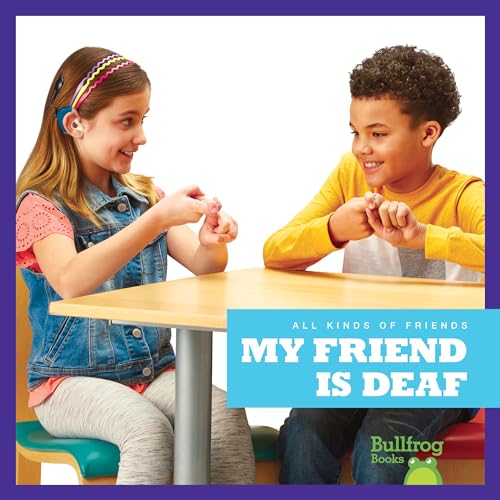 Two children communicating with sign language at a table.