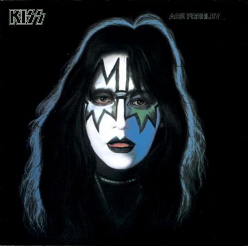 Ace Frehley of KISS with dramatic makeup and long dark hair.