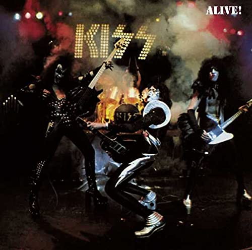 Kiss band members in stage makeup performing with instruments.