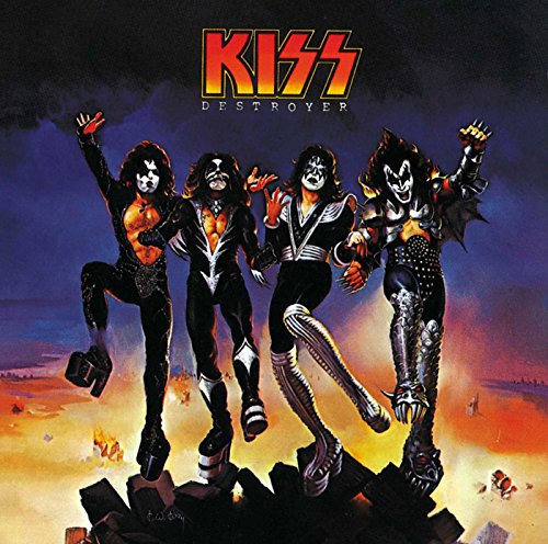 Kiss band members in stage makeup pose amidst a destroyed city.
