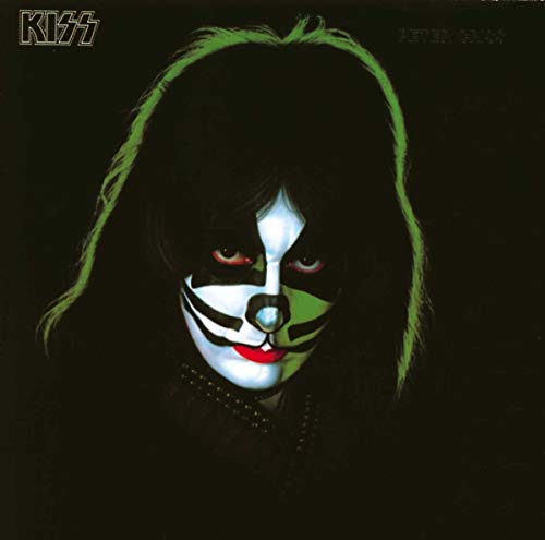 Peter Criss of KISS with cat-style face makeup against a dark background.