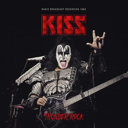 Gene Simmons of KISS performing on stage with bass guitar and iconic makeup.