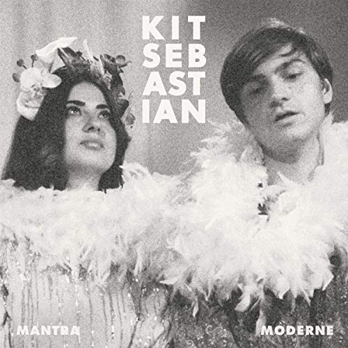 "Black and white album cover with man and woman wearing feathered costumes."