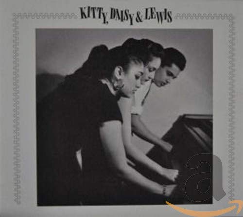 Black and white photo of Kitty, Daisy, and Lewis playing a piano together.