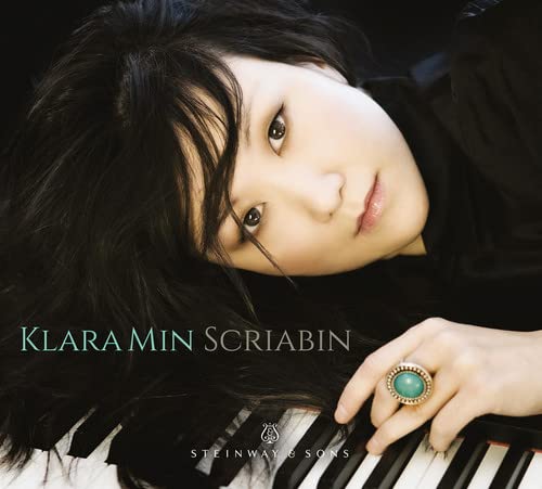 Close-up of pianist Klara Min with piano keys, album cover art.