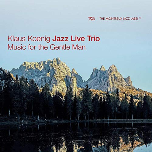 "Album cover with serene mountain landscape, trees, and lake, featuring red text."