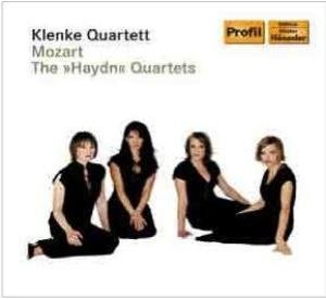 CD cover featuring four women in black outfits sitting on a white background.