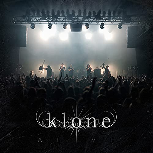 "CD cover with band 'Klone' performing on stage, surrounded by crowd and bright lights."