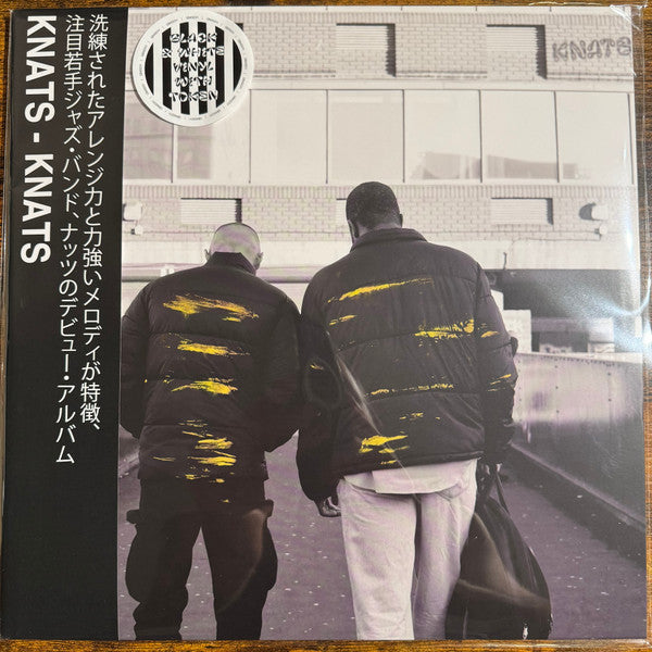 Vinyl record cover featuring two men walking away from the viewer.