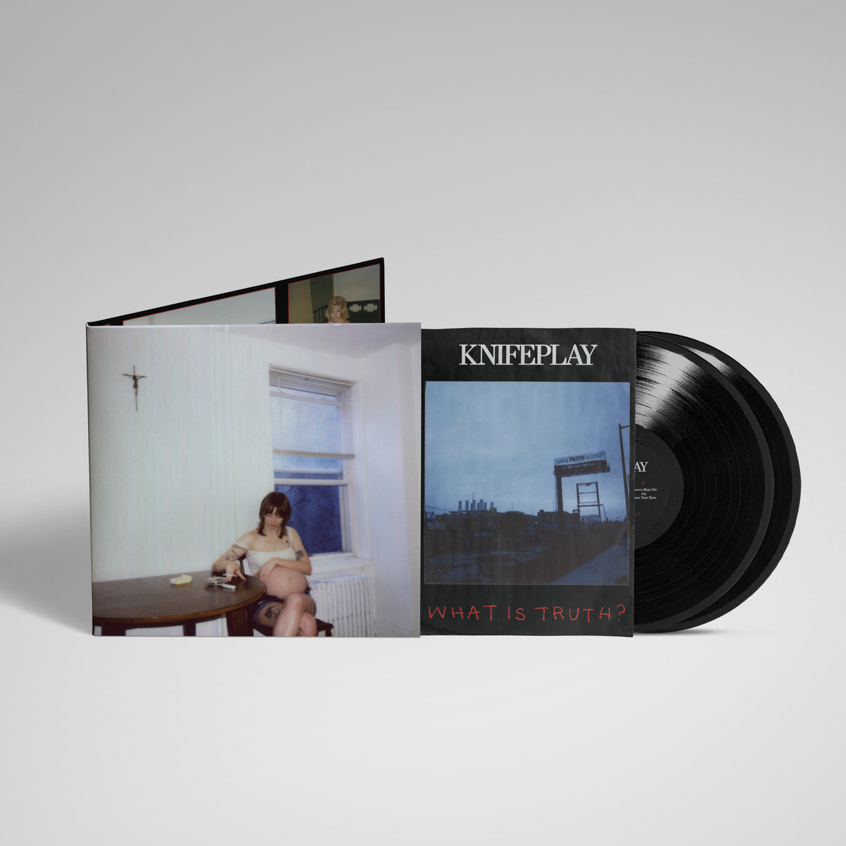 Vinyl record and sleeve with a woman seated at a table.