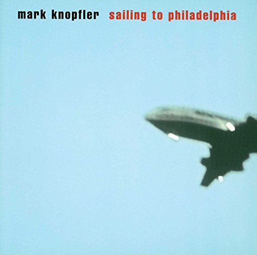 Album cover: airship against a pale blue sky, red text at top.