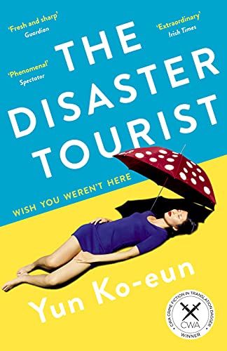 Book cover: “The Disaster Tourist” with a woman under a red umbrella.
