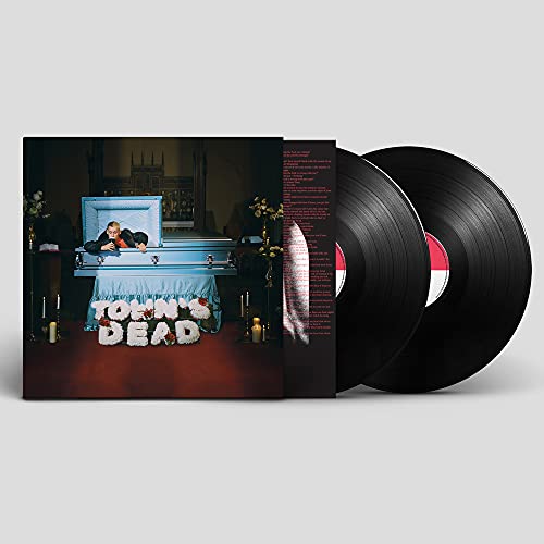Vinyl album cover with a person in an open casket and two records.