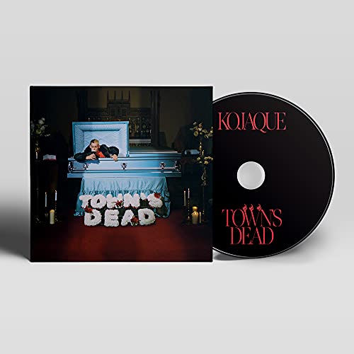 CD cover featuring a person in a coffin with floral arrangements.