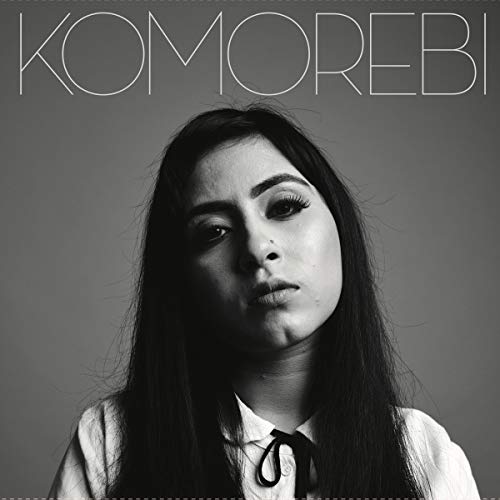 Black and white album cover featuring a woman with long dark hair against a grey background.