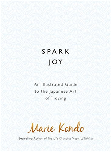 Book cover of "Spark Joy" by Marie Kondo, white background with subtle pattern.