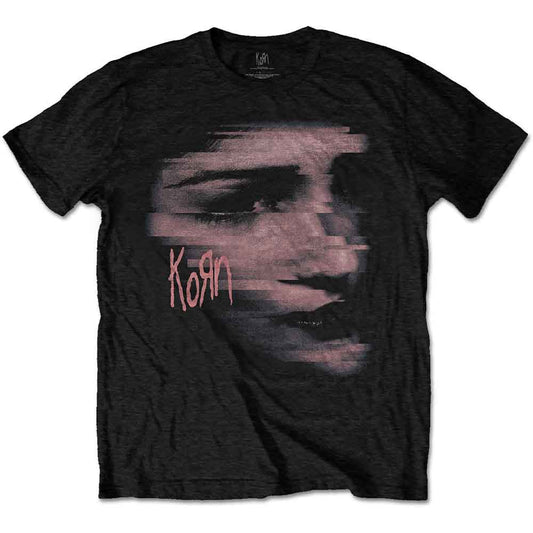 A man wears a black Korn t-shirt featuring a distorted, chopped face graphic.