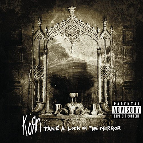 Korn album cover, ornate dark mirror with objects, parental advisory label.