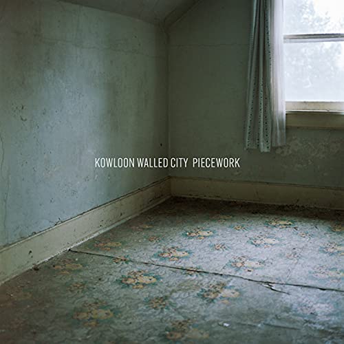 Dilapidated room corner with floral linoleum floor and window.