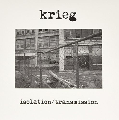 Black and white album cover with factory building behind a chain-link fence.