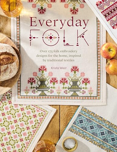 Book cover for Everyday Folk with embroidered textile designs on a wooden table.