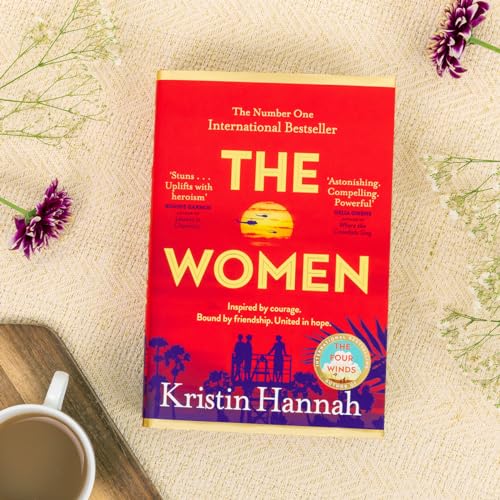 The book cover for The Women by Kristin Hannah features a red background.