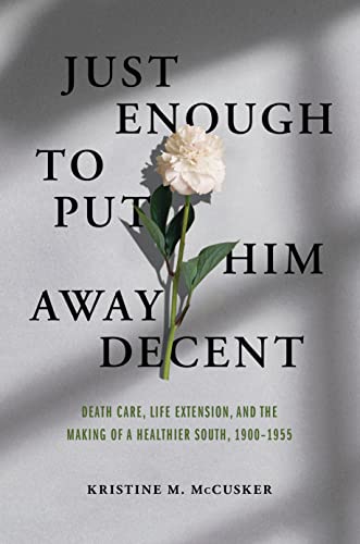 Book cover with white flower and shadowed text: "Just Enough to Put Him Away Decent.