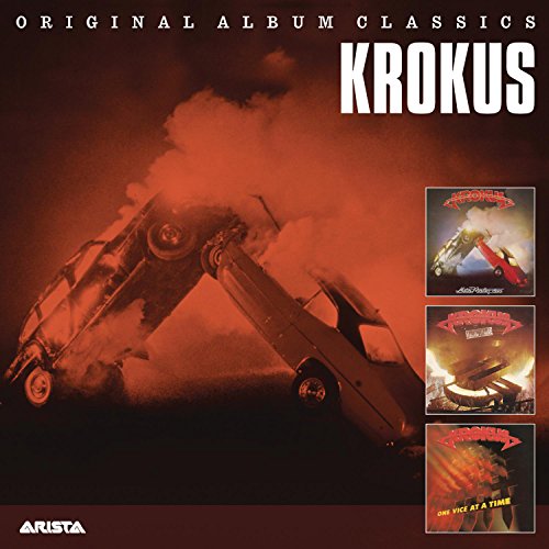 Krokus album cover: fiery car crash scene with album artwork inserts.