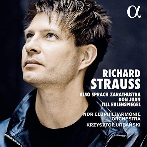 CD cover featuring a man with short hair, wearing a denim jacket, against a dark background.