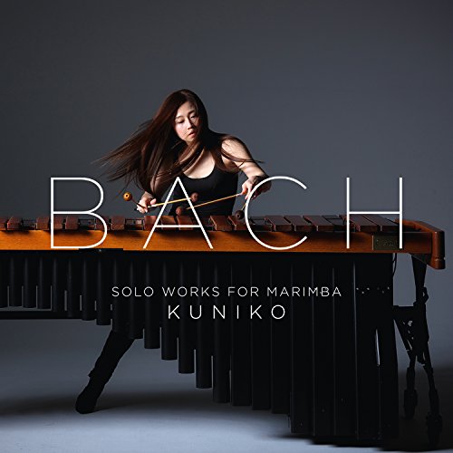 Kuniko playing marimba with "Bach: Solo Works For Marimba" text overlay.