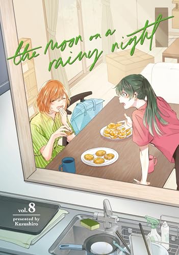 Two girls seen through a window eating pastries at a table in a kitchen.