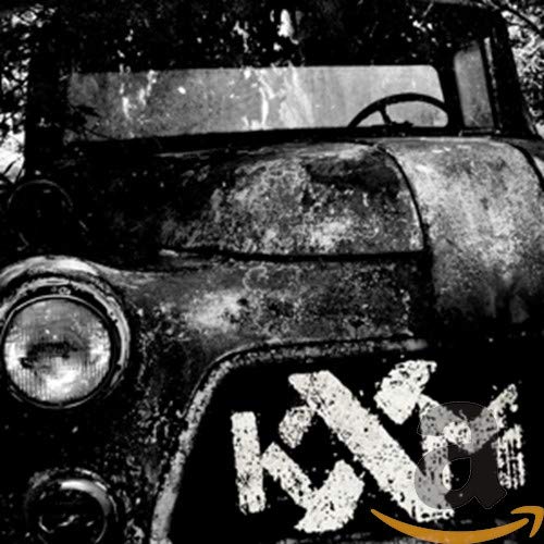 Black and white CD cover featuring a rusted vehicle and “KXM” logo.