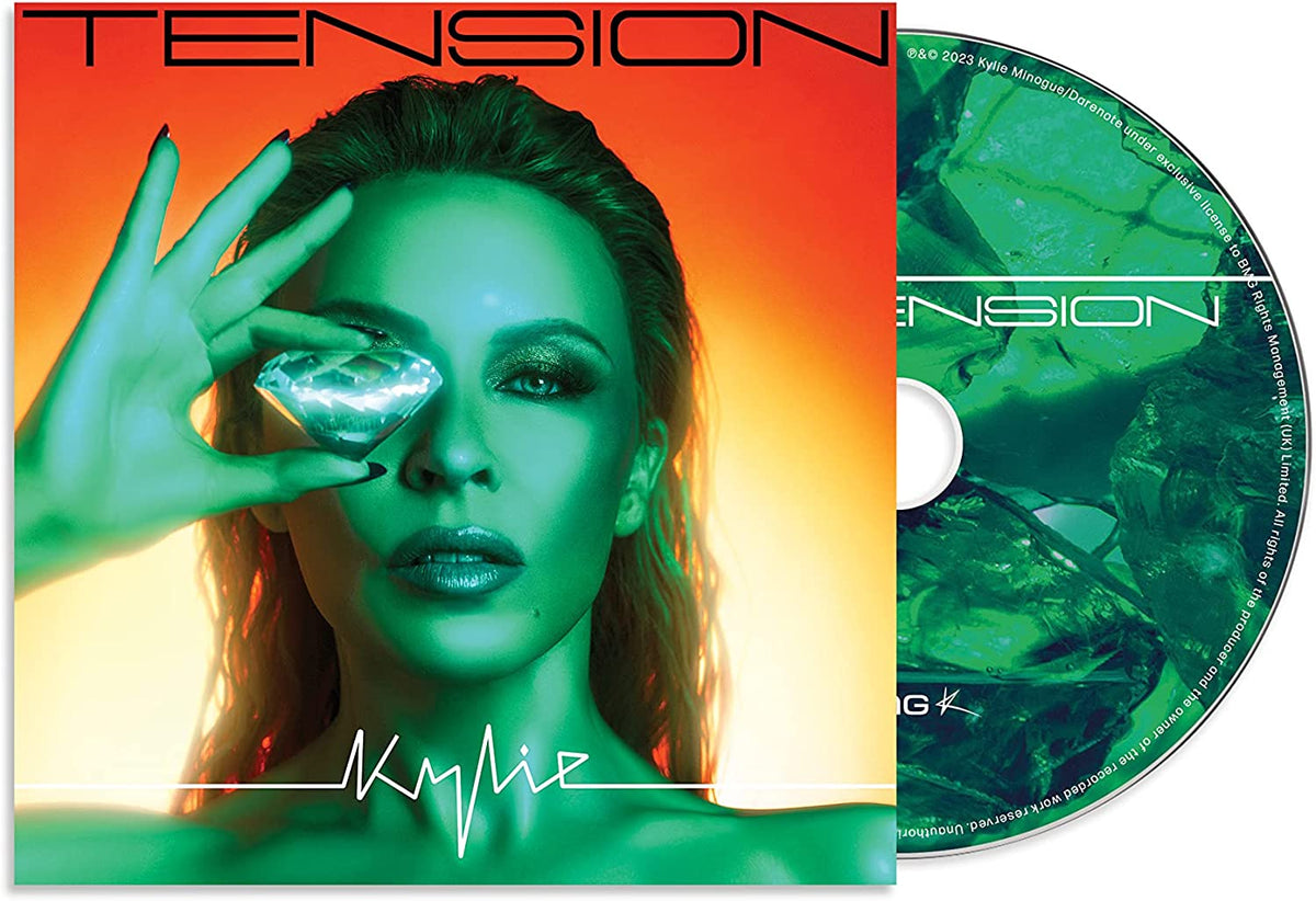 Kylie Minogue's album "Tension" CD cover featuring a woman holding a diamond to her eye.