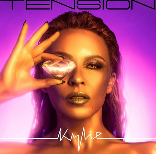 Kylie Minogue holding a diamond over one eye against a purple gradient background.