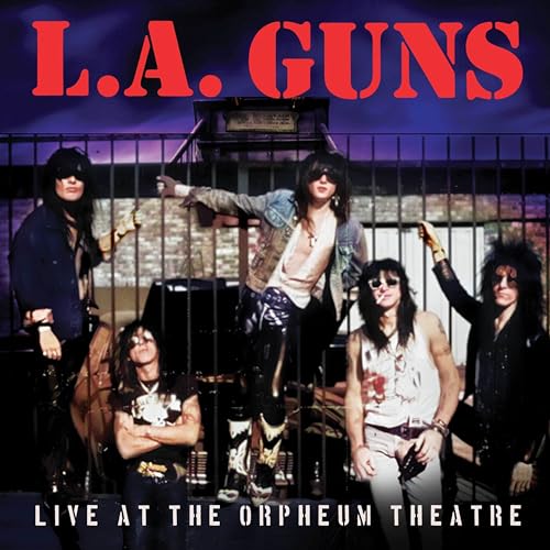 L.A. Guns band members posing in front of a stage with bars.