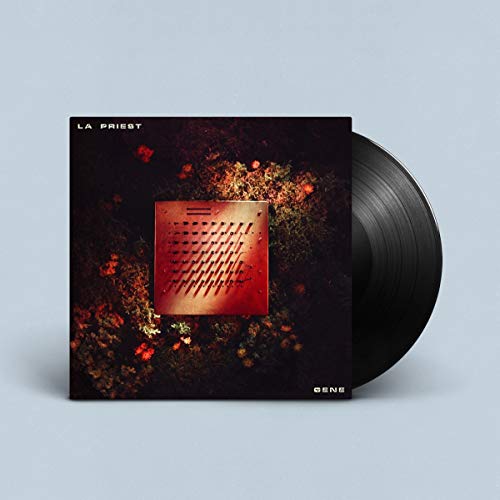 La Priest Gene vinyl record with a square electronic device on a dark background.