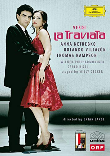 A man in a suit and a woman in a red dress standing together.