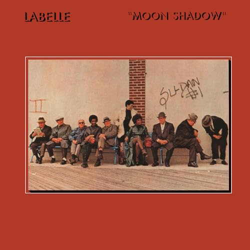 Album cover for Labelle’s “Moon Shadow” featuring a group seated against a brick wall.