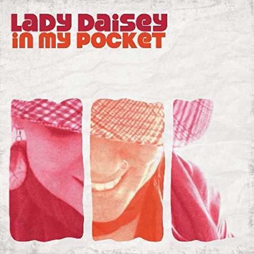 "Album cover featuring three close-up images of a woman's face in pink tones."
