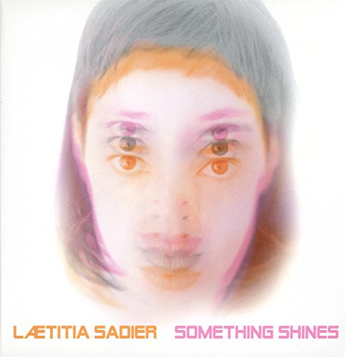 Album cover featuring a blurred, multi-eyed portrait with the artist and title text.